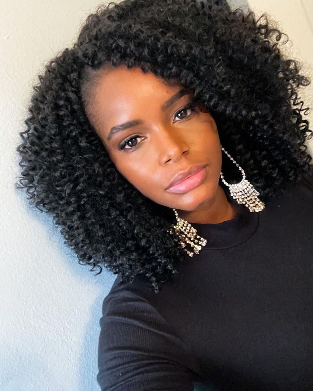 black girl with crochet hair wearing gold rhinestone teardrop dangle earrings
