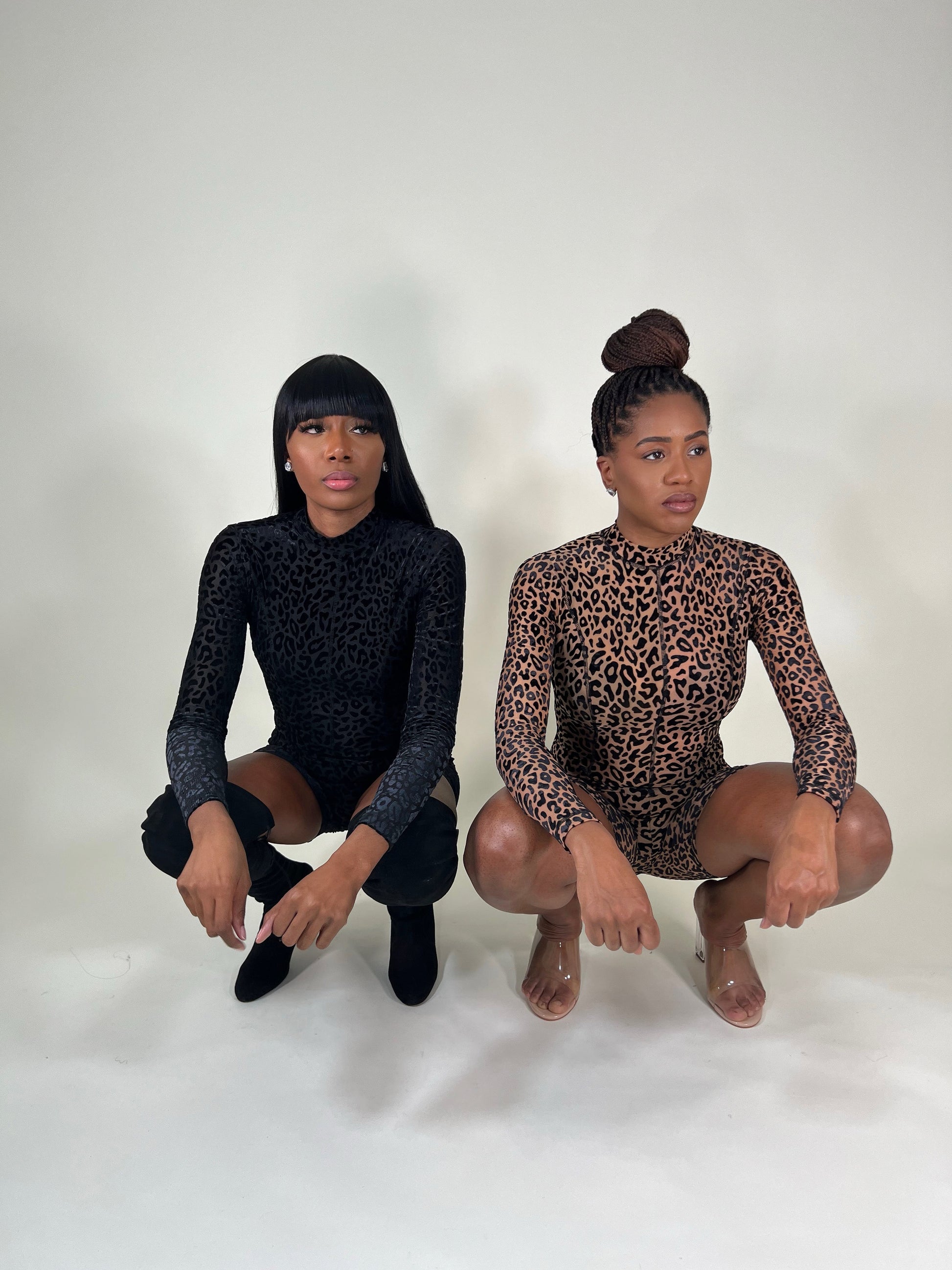 two black girls wearing leopard print rompers